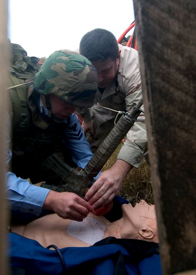 US Navy 071130-N-8534H-001 Hospital Corpsman 2nd Class Erik Mancia prepares to insert a needle into the chest of a simulated casualty during a tactical combat casualty care (TCCC) field training exercise
