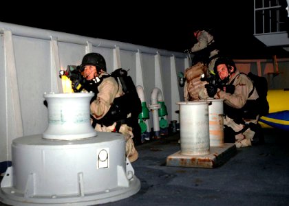 US Navy 071204-N-2838W-249 Members of USS Gonzalez's (DDG 64) visit, boarding, search and seizure team stand look-out as they take part in an actual real-time night boarding simulation of the training support vessel Prevail (TS