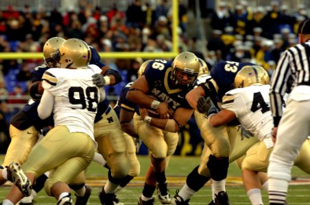 US Navy 071201-N-0989H-674 Fullback for the U.S. Naval academy, Midshipman Eric Kettani, finds a hole in the Black Knights defense