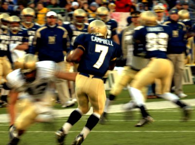 US Navy 071201-N-0989H-626 Offensive team captain and slot back for the U.S. Naval Academy, Midshipman Reggie Campbell, attempts to run past Cadet Matt Eason, linebacker for the U.S. Military Academy