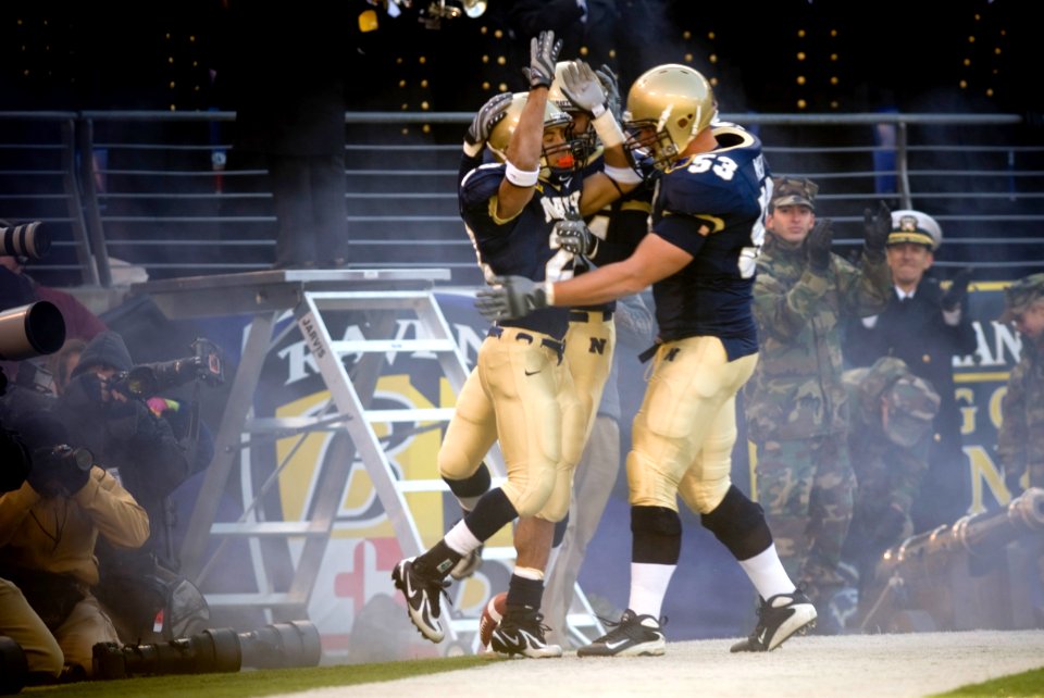US Navy 071201-N-0696M-394 U.S. Naval Academy senior slot back Zerbin Singleton (28) celebrates with his team after scoring the first touchdown