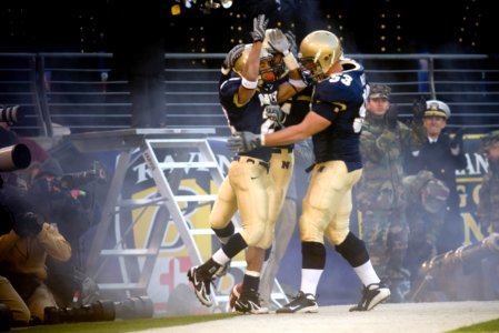 US Navy 071201-N-0696M-394 U.S. Naval Academy senior slot back Zerbin Singleton (28) celebrates with his team after scoring the first touchdown