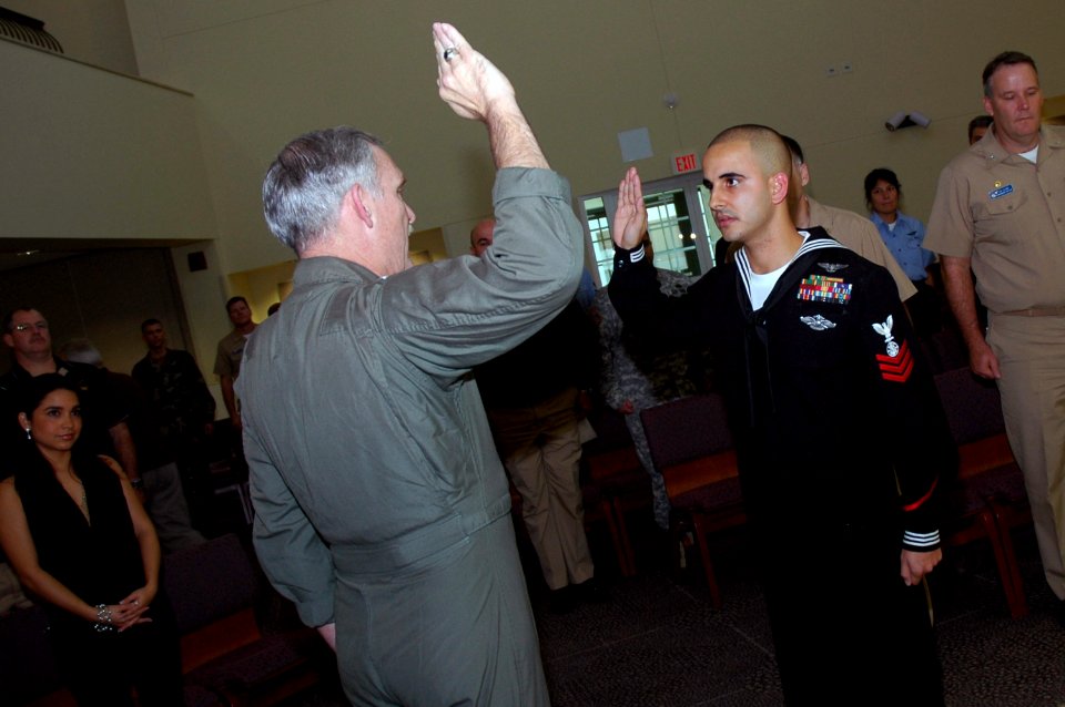 US Navy 071129-N-5821P-001 Religious Program Specialist 1st Class Rafael Barney is reenlisted by Rear Adm. Michael Groothousen, commander of Navy Region Europe (CNRE), during the admiral's site visit to Naval Air Station (NAS)
