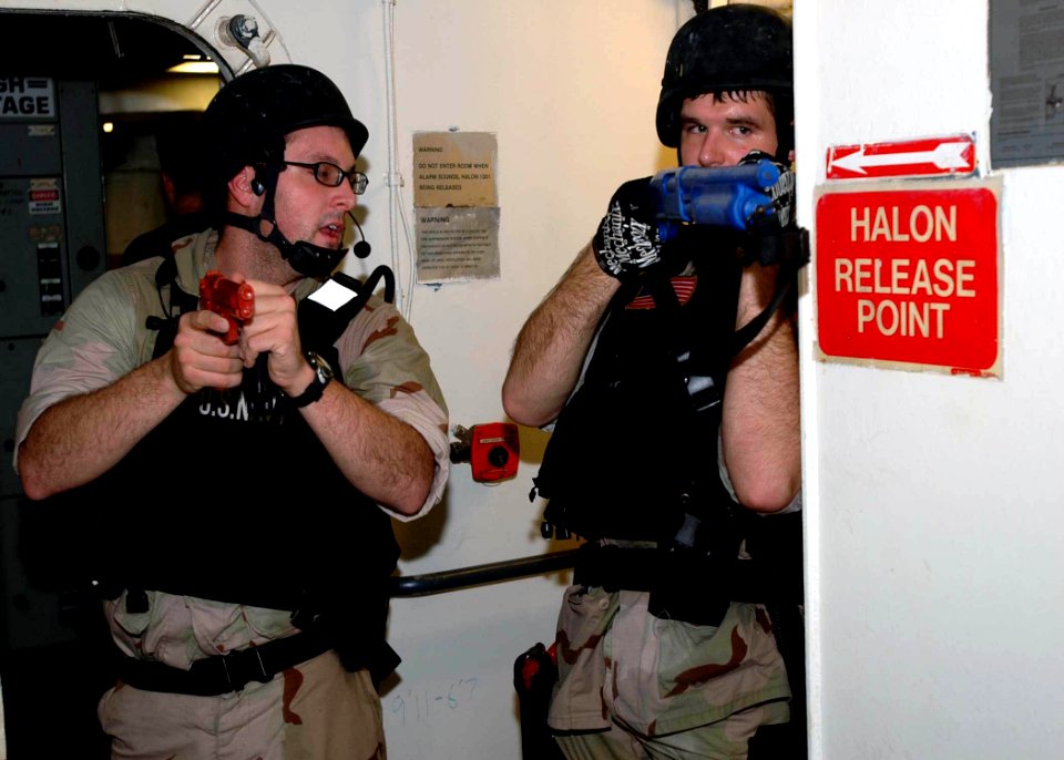 US Navy 071202-N-2838W-071 Two members of the guided-missile destroyer USS Bulkeley's (DDG 84) visit, boarding, search and seizure team communicate during a simulated real-life boarding aboard training support vessel Prevail (T