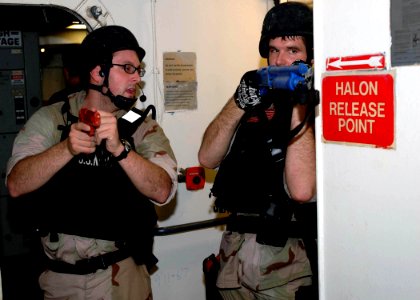 US Navy 071202-N-2838W-071 Two members of the guided-missile destroyer USS Bulkeley's (DDG 84) visit, boarding, search and seizure team communicate during a simulated real-life boarding aboard training support vessel Prevail (T