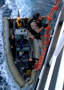 US Navy 071202-N-2838W-050 Members of the guided-missile destroyer USS Bulkeley's (DDG 84) visit, boarding, search and seizure team climb aboard training support vessel Prevail (TSV 1) for a simulated real-life boarding photo
