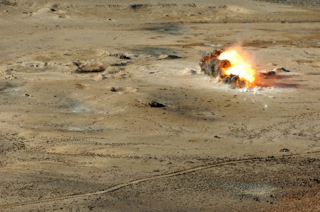 US Navy 071204-N-3931M-306 1,000 pound BLU-110 MK-83 and 500 pound BLU-111 MK-82 hard target penetrating bombs explode at the Gordia range off the coast of Djibouti photo