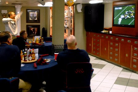 US Navy 071202-N-4133B-021 Commanding Officer Capt. Terry B. Kraft signals first down during the annual Army vs. Navy football game in the wardroom aboard the Nimitz-class nuclear-powered aircraft carrier USS Ronald Reagan