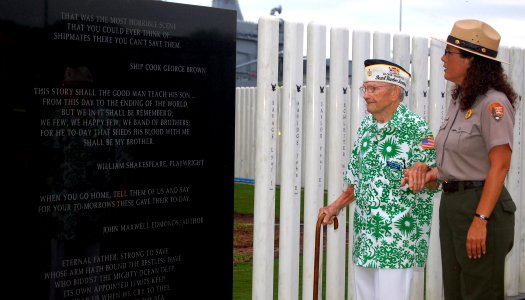 US Navy 071203-N-0879R-006 Pearl Harbor survivor Senior Chief George A. Brown (Ret.) speaks with Eileen Martinez of the National Park Service about the 429 Sailors who perished during the Pearl Harbor attack aboard battleship U