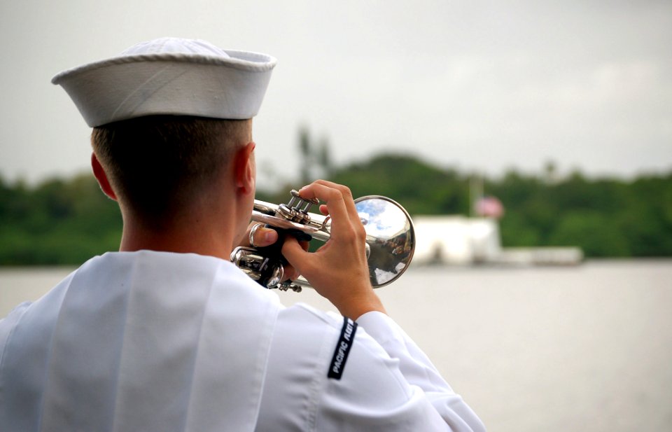US Navy 071207-N-0879R-135 A Sailor assigned to the Pacific Fleet Band plays taps during a joint U.S. Navy-National Park Service ceremony commemorating the 66th Anniversary of the attack on Pearl Harbor