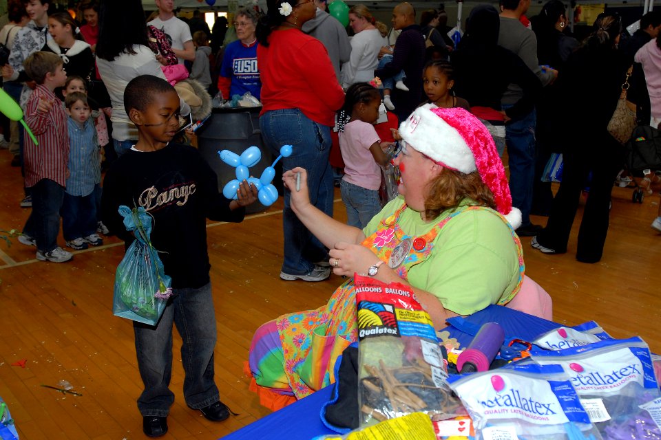 US Navy 071201-N-1082Z-003 Children of service members receive balloon animals made by volunteers at the USO of Hampton Roads 13th annual Holiday Party, held at Naval Amphibious Base Little Creek