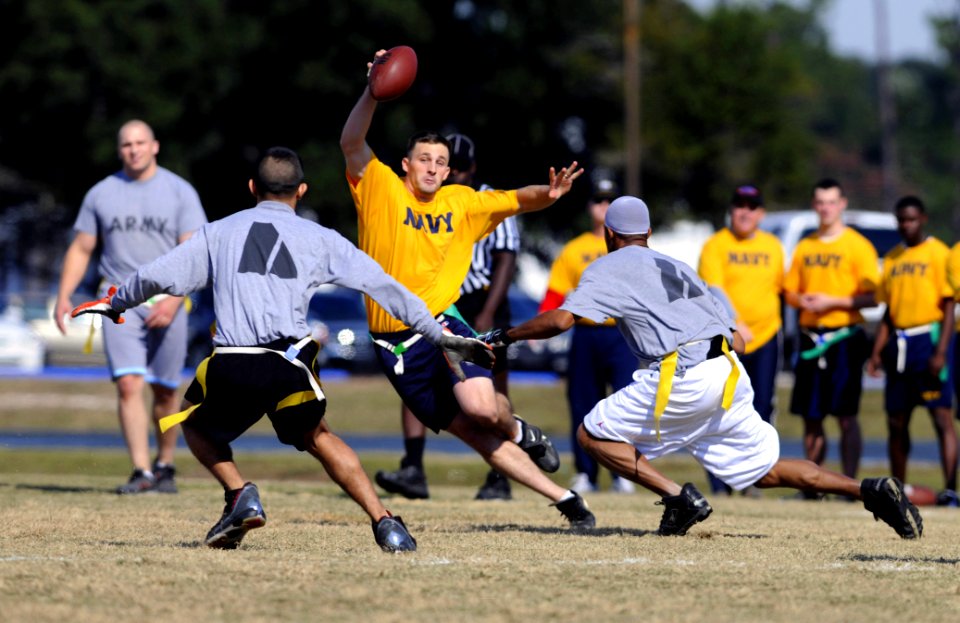 US Navy 071201-N-5328N-586 Quarterback and Cryptologic Technician (Technical) 1st Class Jakob Chauvin runs through a gauntlet of Army defenders during the fifth annual CID Corry Station Flag Football Game at Corry Station