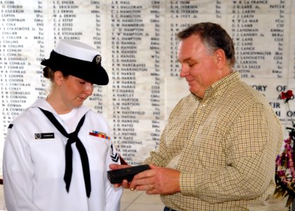 US Navy 071207-N-5476H-234 Tim Hodges presents his niece, Cryptologic Technician Interpretive (CTI) 2nd Class Bailey Sharbrough with the Purple Heart awarded to her great uncle Garris Hodges aboard the USS Arizona Memorial