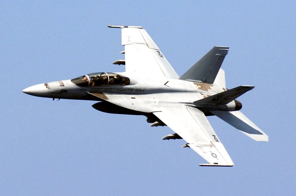 US Navy 071203-N-8923M-074 An F-A-18F Super Hornet, from the Red Rippers of Strike Fighter Squadron (VFA) 11, makes a sharp turn above the flight deck aboard the Nimitz-class nuclear-powered aircraft carrier USS Harry S. Truman
