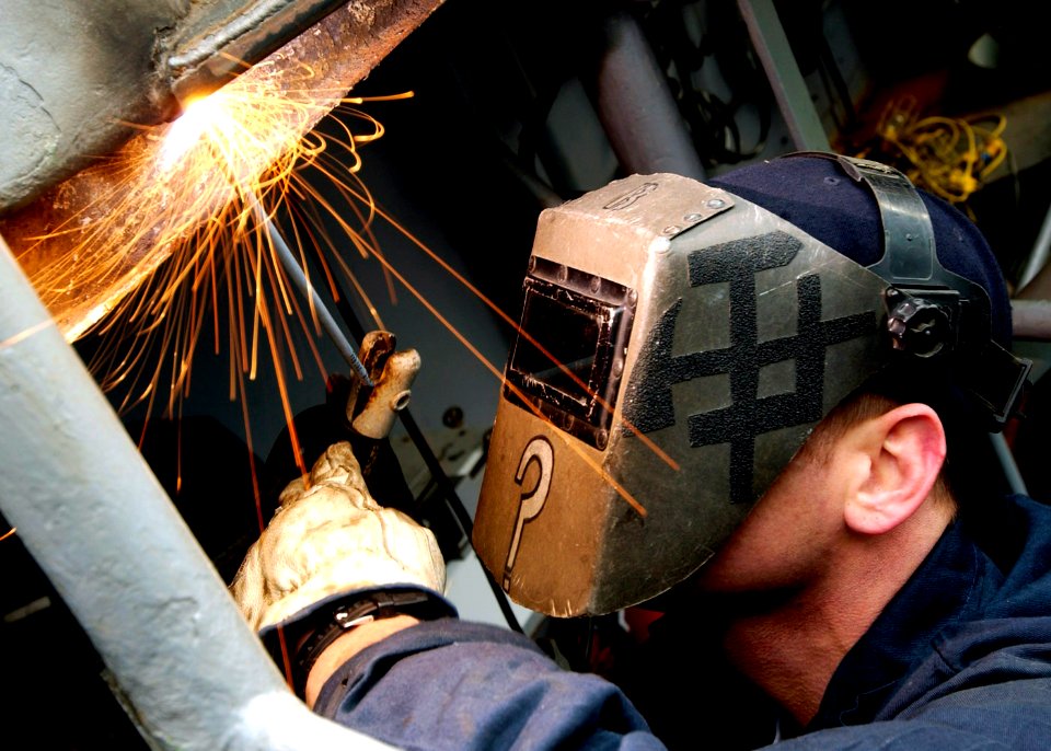 US Navy 071204-N-7571S-002 Hull Technician 3rd Class Craig Baker welds the Landing Signal Officer's platform to prepare it for normal flight operations aboard the nuclear-powered aircraft carrier USS Theodore Roosevelt (CVN 71