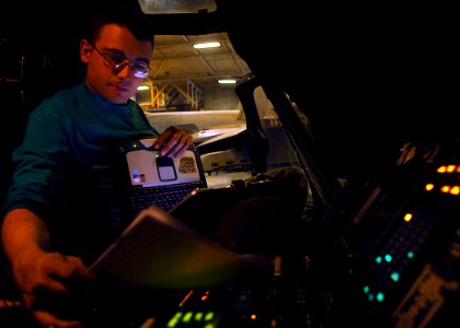 US Navy 071204-N-1598C-012 Aviation Electronics Technician 3rd Class Cody Green performs checkout procedures on the tactical air navigation system of an SH-60F Seahawk