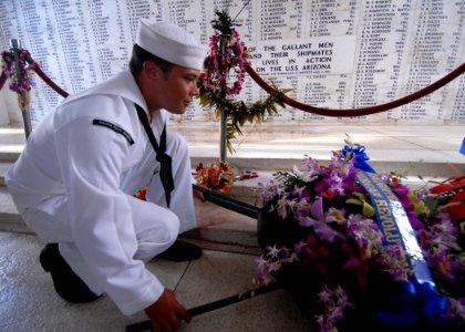 US Navy 071204-N-9758L-067 Seaman Apprentice Chaz Chesnek, assigned to Naval Station (NAVSTA) Pearl Harbor, lays down a wreath in the shrine room of USS Arizona Memorial