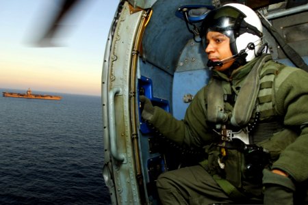 US Navy 071205-N-1598C-026 Aviation Warfare Systems Operator 2nd Class Brent Blackwell, looks out of from the doorway of a SH-60F Seahawk