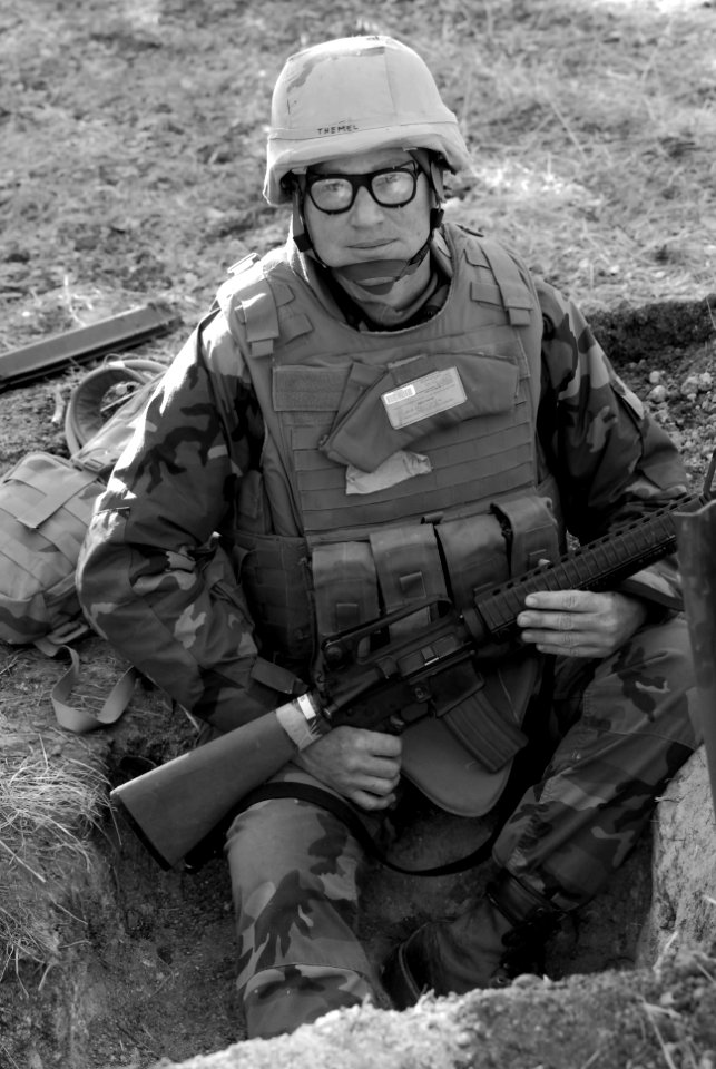 US Navy 071209-N-9623R-009 From a dug-in fighting position on board Camp Eagle, Utilitiesman 1st Class James Themel, of Naval Mobile Construction Battalion (NMCB) 17, grasps his M-16 rifle