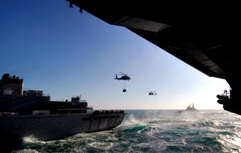 US Navy 071212-N-2984R-160 Two MH-60S Seahawks perform vertical replenishment during a replenishment-at-sea