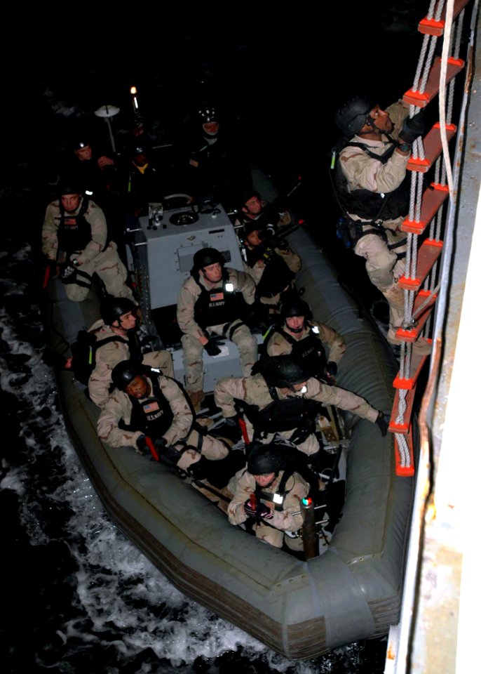 US Navy 071204-N-2838W-214 A member of USS Gonzalez's (DDG 64) visit, boarding, search and seizure team embarks the training support vessel Prevail (TSV 1) for a real-time night simulation boarding exercise