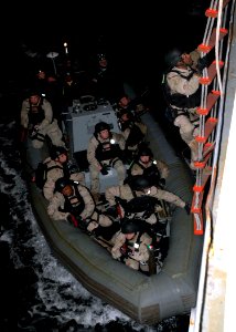 US Navy 071204-N-2838W-214 A member of USS Gonzalez's (DDG 64) visit, boarding, search and seizure team embarks the training support vessel Prevail (TSV 1) for a real-time night simulation boarding exercise
