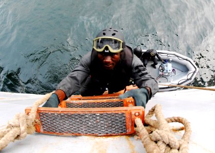 US Navy 071214-N-8933S-075 A Cameroonian Navy sailor climbs aboard the amphibious dock landing ship USS Fort McHerny (LSD 43) during the final graded scenario on vessel, board, search and seizure techniques