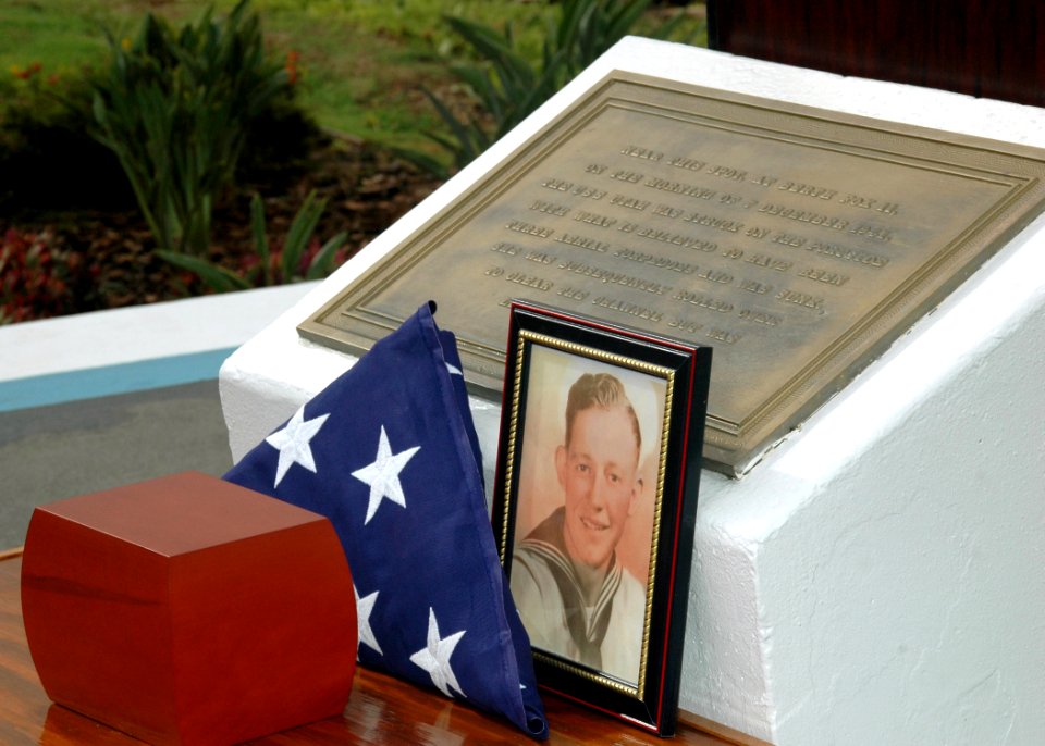 US Navy 071207-N-7310D-013 An American flag and a picture of Richard Adams are on display during an internment ceremony for Adams at the USS Utah Memorial