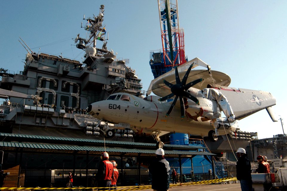 US Navy 071205-N-3136P-027 A Carrier Airborne Early Warning Squadron (VAW) 115 E-2C Hawkeye is lowered onto the pier from the flight deck of the aircraft carrier USS Kitty Hawk (CV 63)