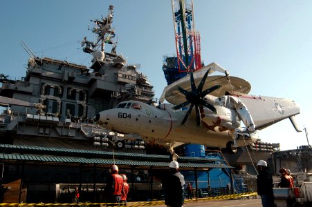 US Navy 071205-N-3136P-027 A Carrier Airborne Early Warning Squadron (VAW) 115 E-2C Hawkeye is lowered onto the pier from the flight deck of the aircraft carrier USS Kitty Hawk (CV 63)