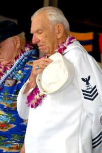 US Navy 071207-N-5476H-177 Pearl Harbor survivor Charles A. Smith bows his head during the benediction at the start of the joint U.S. Navy-National Park Service ceremony commemorating the 66th Anniversary of the attack on Pearl