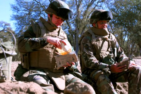 US Navy 071206-N-0775Y-025 Seabees attached to Naval Mobile Construction Battalion (NMCB) 3, sit in a fighting pit as they take a break to eat a meal-ready-to-eat (MRE)