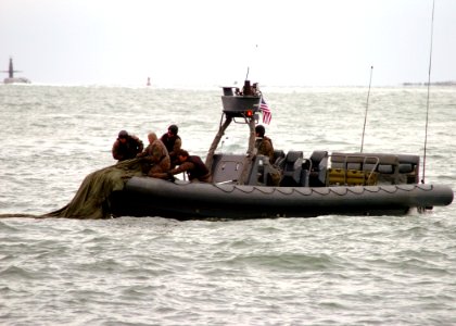 US Navy 071205-N-4205W-455 Special Warfare Combatant-craft Crewmen (SWCC) recover parachutes after a successful launch of the Maritime Craft Aerial Deployment System (MCADS) photo