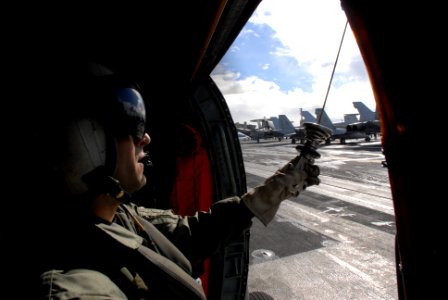 US Navy 071209-N-3659B-012 Aviation Warfare Systems Operator 2nd Class Jeremiah Rivera performs pre-flight checks on an SH-60F Seahawk helicopter