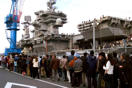 US Navy 071208-N-9520G-003 Thousands of Japanese visitors wait in line for a chance to tour America's only permanently forward-deployed aircraft carrier USS Kitty Hawk (CV 63) during the Grand Illumination