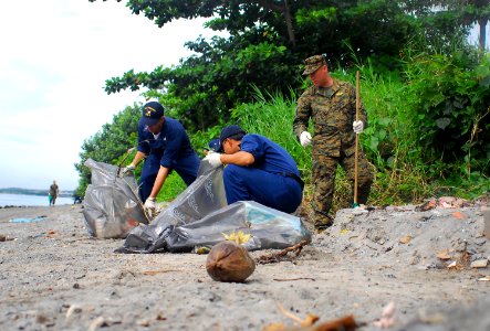 US Navy 071217-N-4774B-154 Sailors from amphibious assault ship USS Tarawa (LHA 1), guided-missile destroyer USS Hopper (DDG 70) and Marines from 11th Marine Expeditionary Unit clean trash and debris from local beaches on the i
