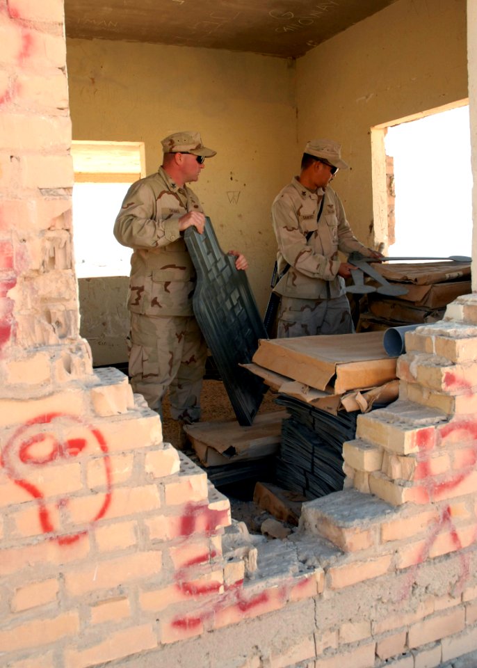 US Navy 071209-N-3857R-006 Storekeeper 1st Class Joseph Sanchez and Builder 1st Class Billy Thomas, both attached to Naval Mobile Construction Battalion (NMCB) 1, grab targets prior to weapons familiarization training
