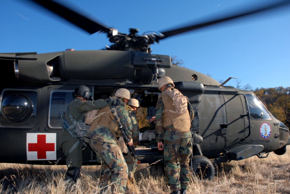 US Navy 071211-N-9623R-003 Seabees from Naval Mobile Construction Battalion (NMCB) 17 load a patient into a UH-60 Blackhawk medical evacuation helicopter