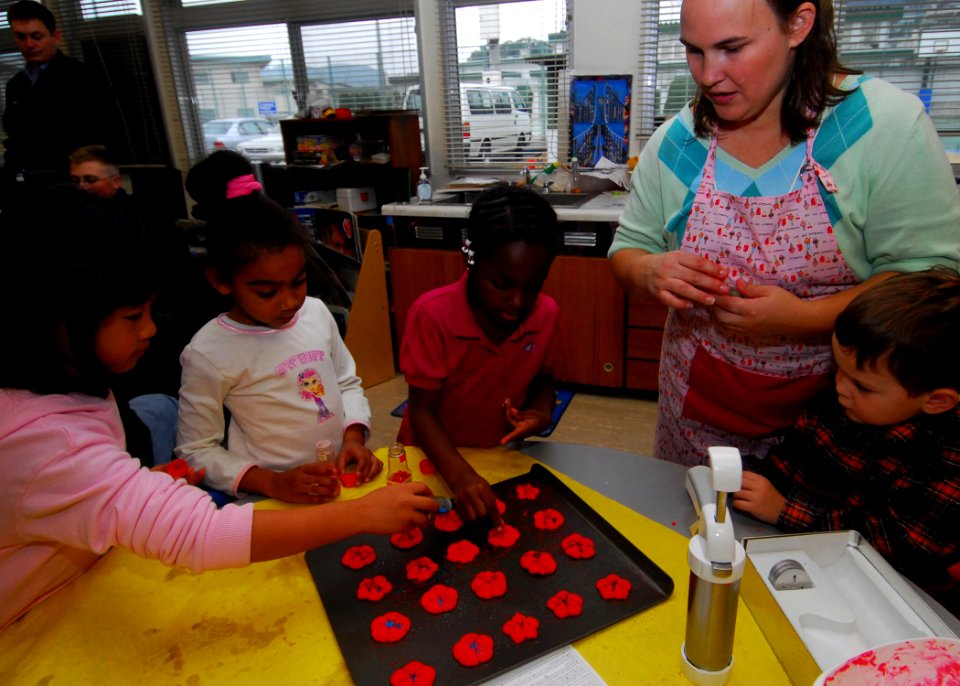 US Navy 071207-N-0807W-012 First and second-graders from Sasebo Elementary School, with the help of the United Service Organizations (USO), bake holiday cookies for Sasebo's single Sailors