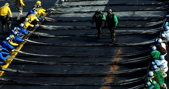 US Navy 071217-N-1688B-121 Sailors prepare to raise an aircraft barrier during a crash drill aboard the Nimitz-class nuclear-powered aircraft carrier USS Harry S. Truman (CVN 75)