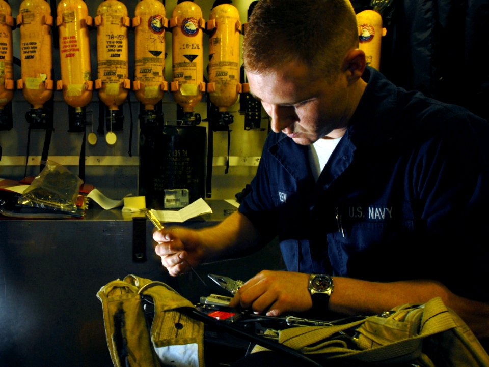 US Navy 071207-N-1688B-232 Damage Controlman Fireman Dominic Green performs regular maintenance to the self contained breathing apparatus aboard the Nimitz-class nuclear-powered aircraft carrier USS Harry S. Truman (CVN 75)