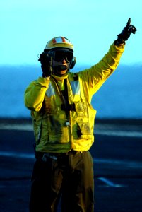 US Navy 071213-N-0555B-013 An aviation boatswain's mate (handling) directs an aircraft on the flight deck of the Nimitz-class nuclear-powered aircraft carrier USS Ronald Reagan (CVN 76)