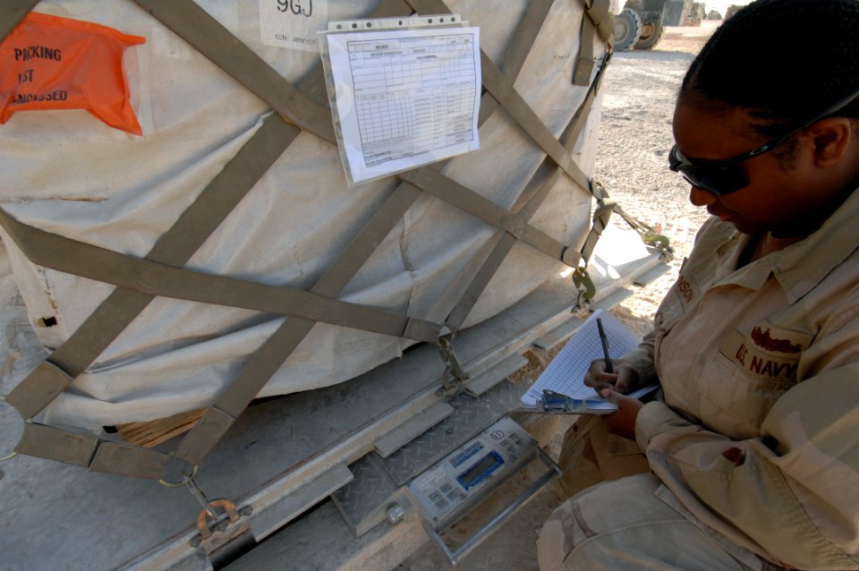 US Navy 071217-N-7027P-133 Seaman Juanita Johnson attached to Cargo Transfer Platoon (CTP) 3, documents the weight of a palette to ensure that it meets the weight restrictions of the cargo plane
