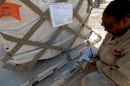 US Navy 071217-N-7027P-133 Seaman Juanita Johnson attached to Cargo Transfer Platoon (CTP) 3, documents the weight of a palette to ensure that it meets the weight restrictions of the cargo plane
