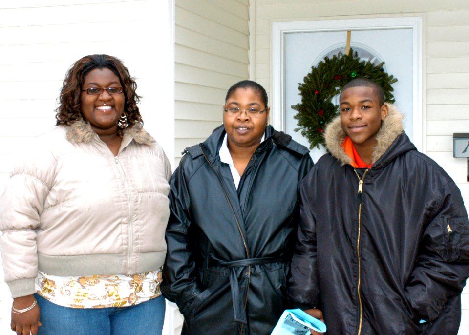 US Navy 071215-N-4680O-001 New homeowners Lateshia, Sylvia, and Tyrell Walton stand in front of their new home built by Habitat for Humanity