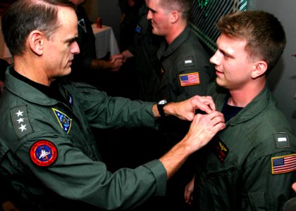 US Navy 071208-N-3069F-003 Commander, Naval Air Forces, Vice Adm. Tom Kilcline, places a squadron patch on Lt. j.g. Troy Leveran during a Fleet Up ceremony held at the 19th Hole Sea and Air Golf Restaurant