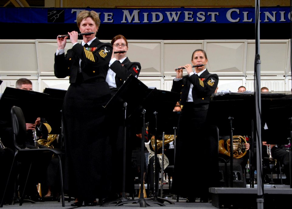 US Navy 071219-N-0773H-106 Master Chief Musician Betty R. Myers, left, Musician 1st Class Jennifer D. Smith, center and Chief Musician Luellyn K. Dollard play the piccolo with the Navy Band during The Stars and Stripes Forever