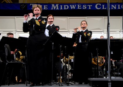 US Navy 071219-N-0773H-106 Master Chief Musician Betty R. Myers, left, Musician 1st Class Jennifer D. Smith, center and Chief Musician Luellyn K. Dollard play the piccolo with the Navy Band during The Stars and Stripes Forever