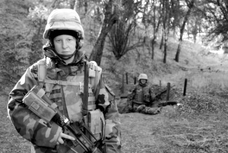 US Navy 071209-N-9623R-004 Utilitiesman Constructionman Nicola Angle, assigned to Naval Mobile Construction Battalion (NMCB) 17, stands behind her fortified fighting position on the defensive lines of Camp Eagle