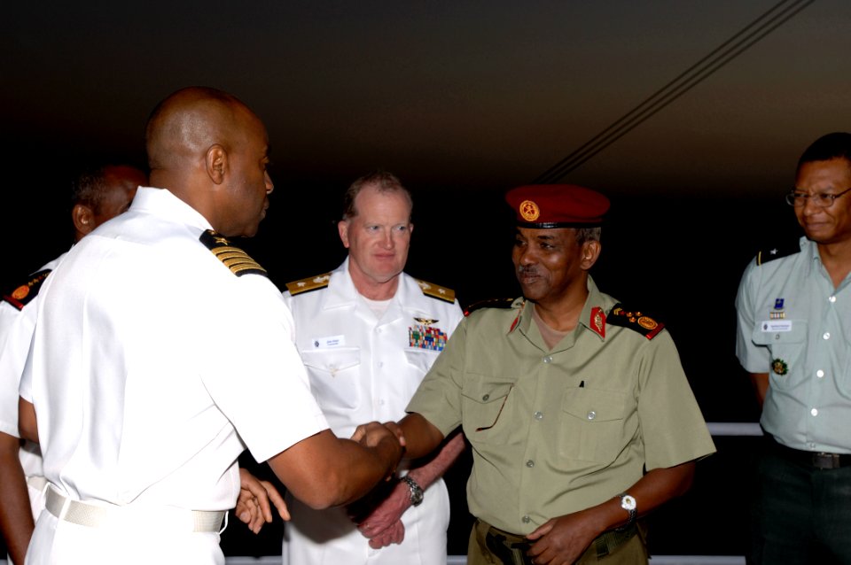 US Navy 071215-F-0509T-091 U.S. Navy Commodore Frank Ponds presents Djiboutian Army Brig. Gen. Osman Soubagleh with a coin during a reception at end the Operation Image Nautilus aboard USS Gunston Hall (LSD 44)